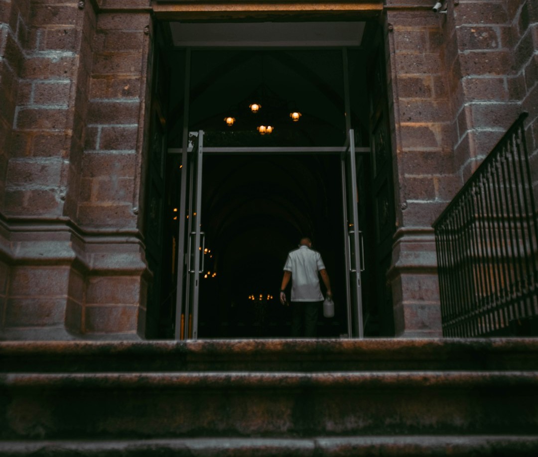 a man walking out of a doorway into a building