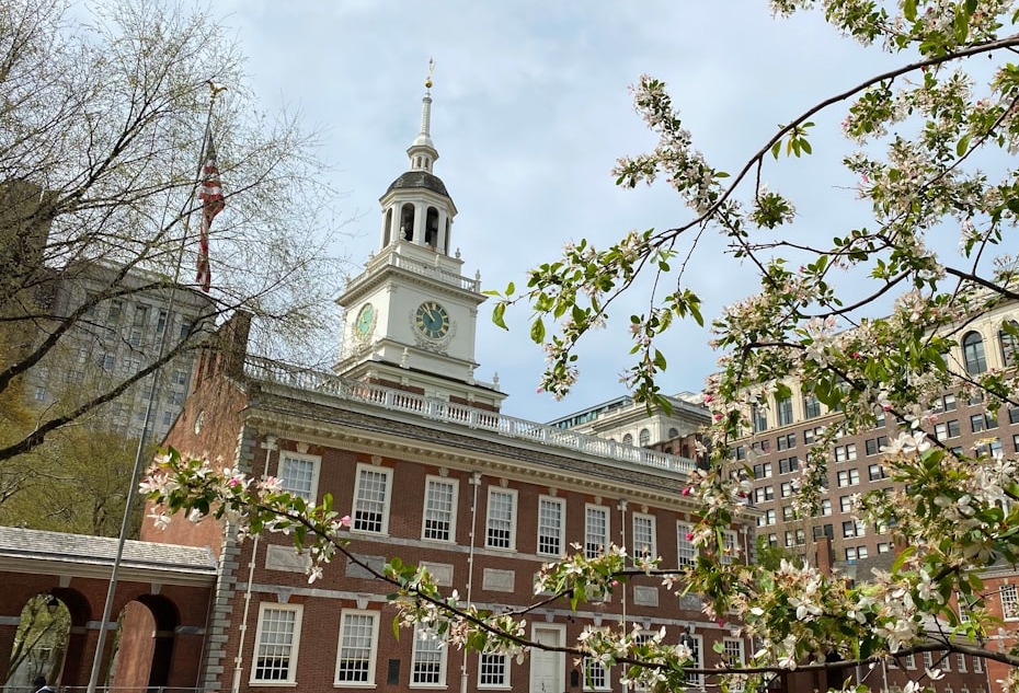 a large building with a clock tower with Maryland State House in the background